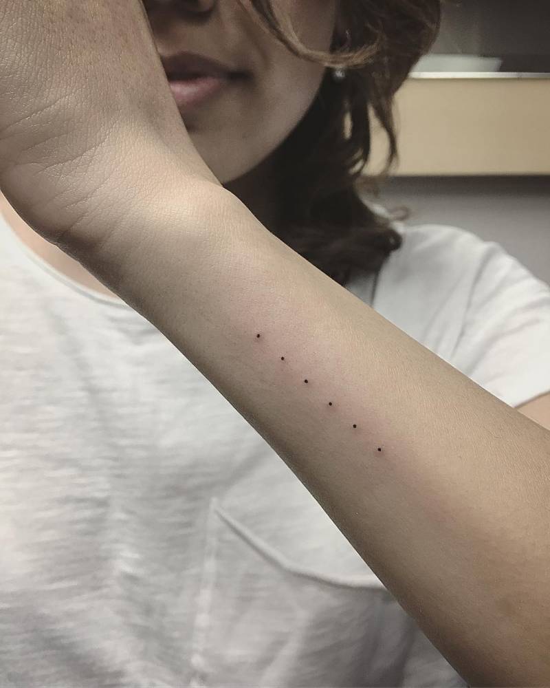 Six dots tattoo on the forearm