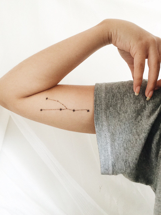 Small Taurus constellation tattoo on the right bicep