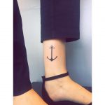Small black anchor tattoo on the ankle