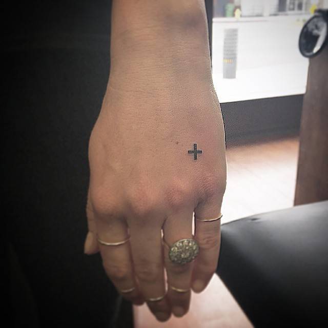 Small black cross on the hand