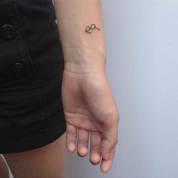 Small glasses tattoo on the wrist