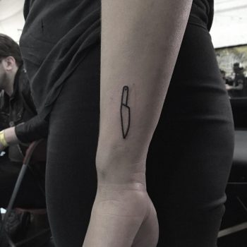 Small knife tattoo on the wrist