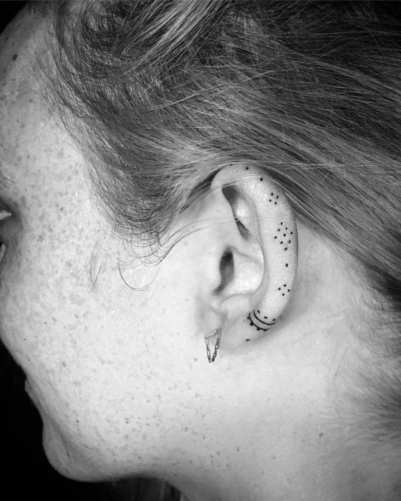 Small ornament tattoo on the ear