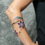 Snowflake and abstract colorful lines tattoo