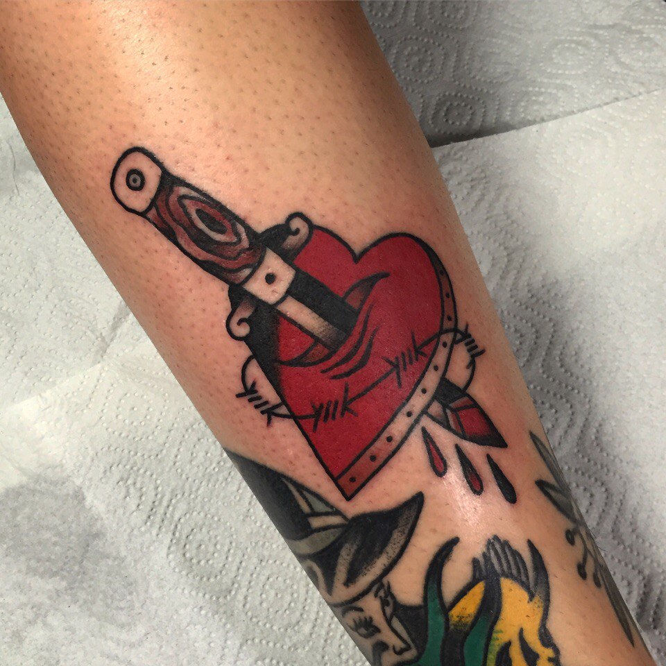 Stabbed heart and barbed wire tattoo