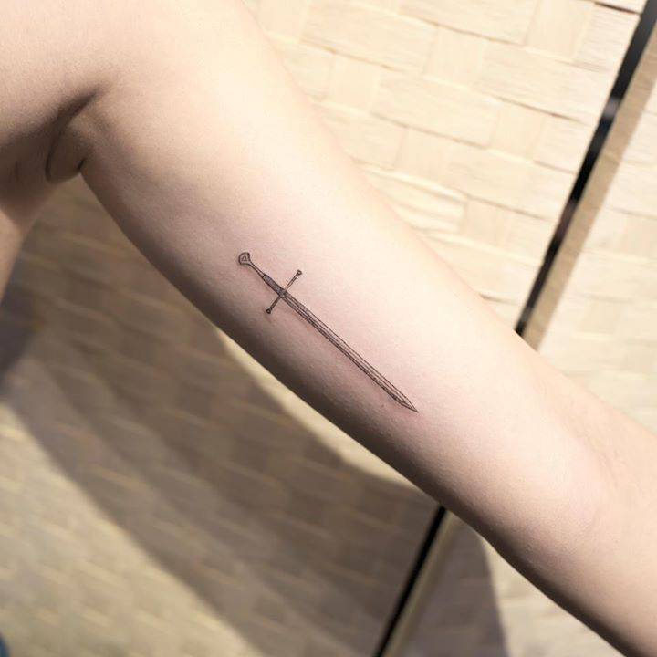 Sword tattoo on the bicep - Tattoogrid.net