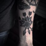 Three crossed arrows and flower tattoo