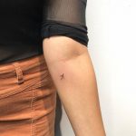 Tiny airplane tattoo on the forearm