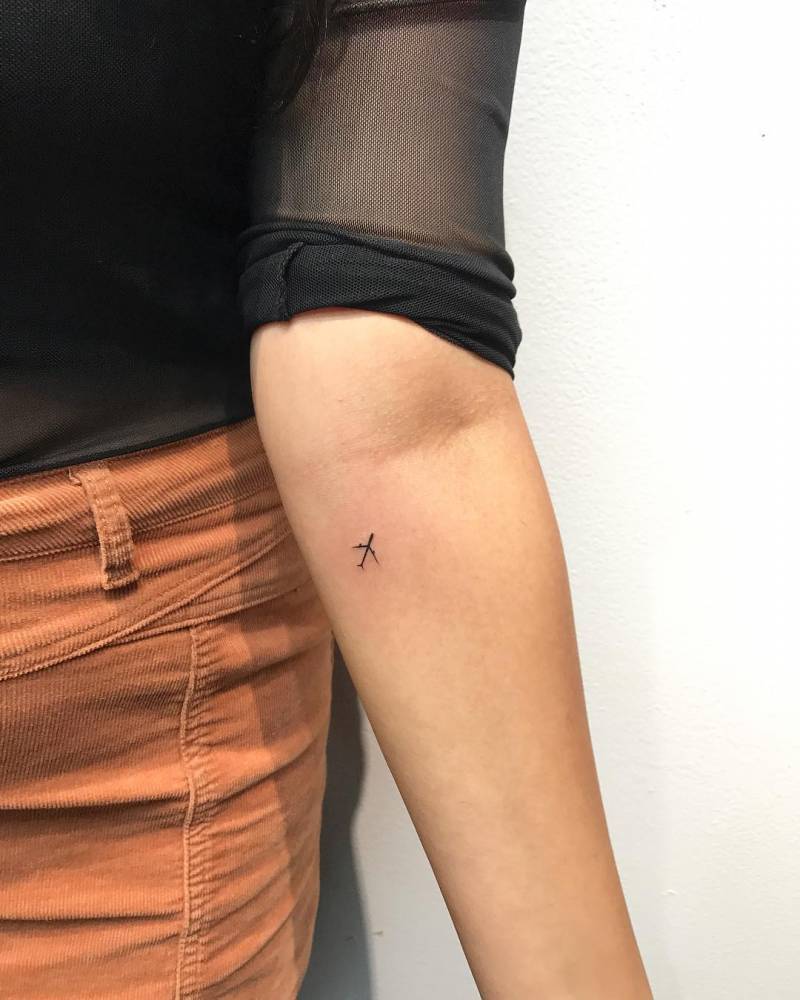 Tiny airplane tattoo on the forearm