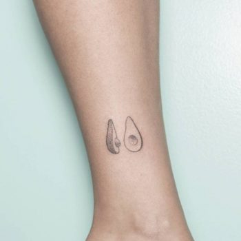 Tiny black and gray avocado tattoo