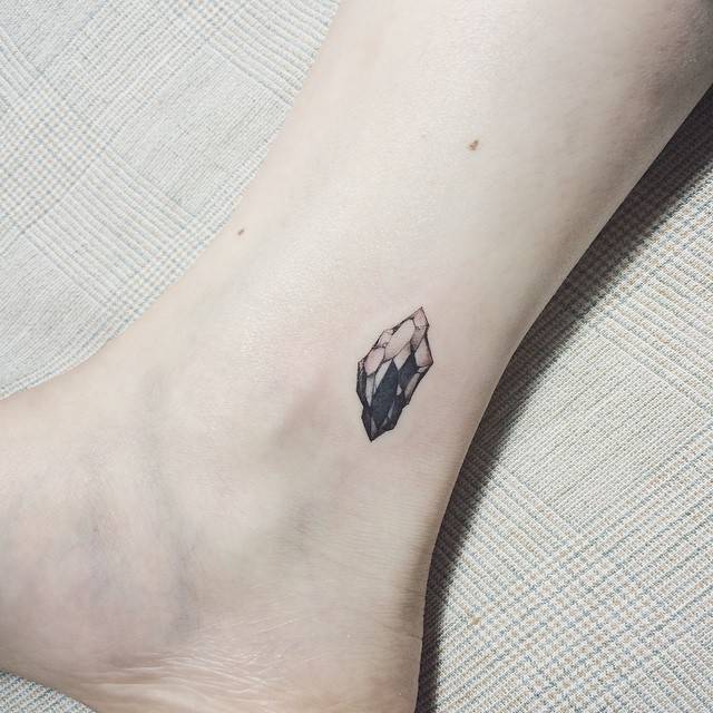Tiny crystal tattoo on the inner ankle
