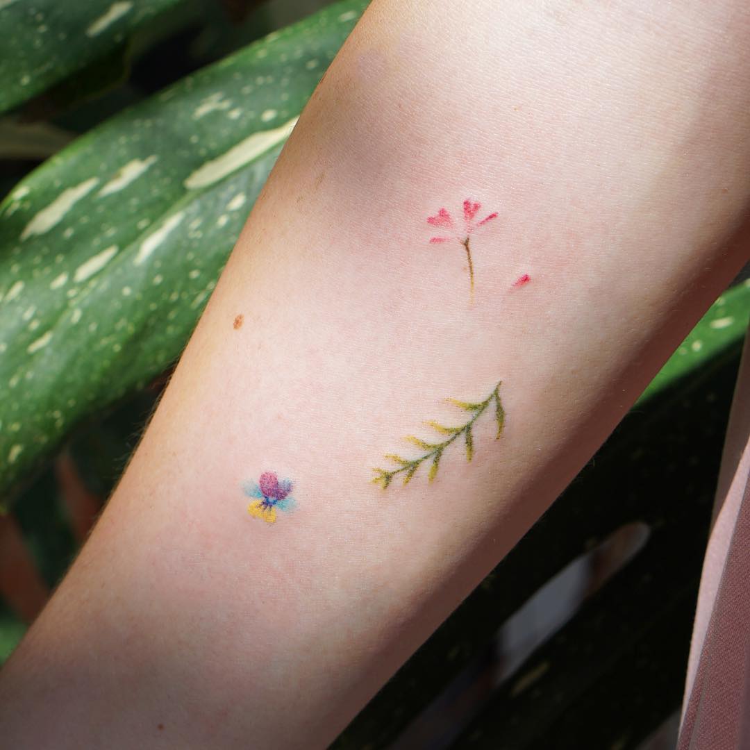 Tiny hand poked tattoos on the arm