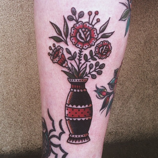 Traditional colored tattoo of vase with flowers