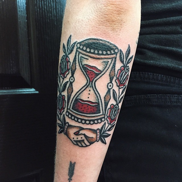 Traditional hourglass tattoo on the forearm