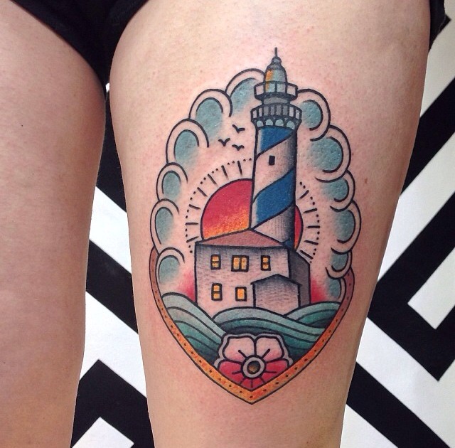Traditional lighthouse tattoo on the thigh