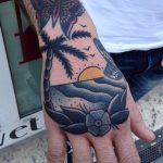 Traditional sunset tattoo on the hand