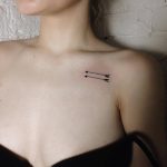 Two arrows tattoo on the collarbone