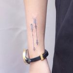 Two watercolor arrow tattoos