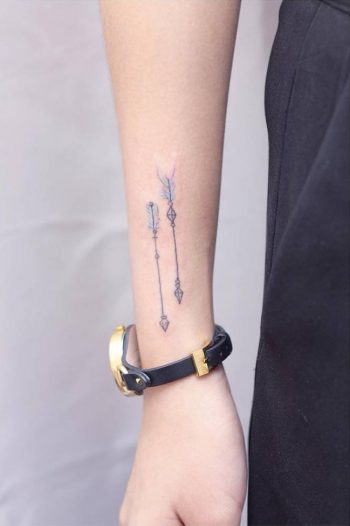 Two watercolor arrow tattoos