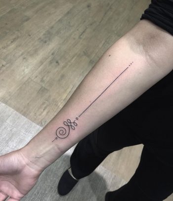 Unalome and black long line tattoo on the forearm 