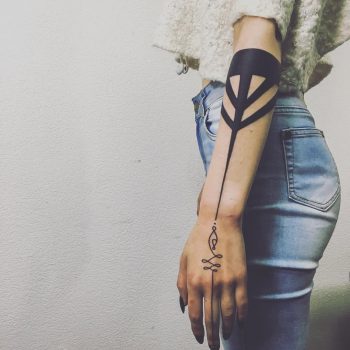 Unalome and black ornament tattoo