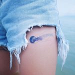 Watercolor jellyfish tattoo on the left thigh
