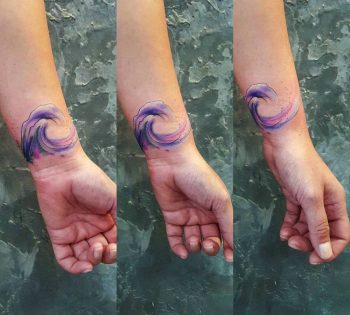 Watercolor wave tattoo on the wrist