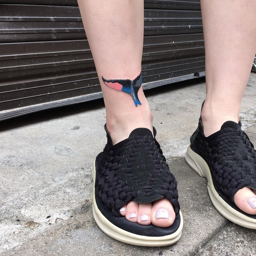 Whale tail tattoo on the ankle