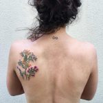 Wildflower tattoo on the left shoulder blade