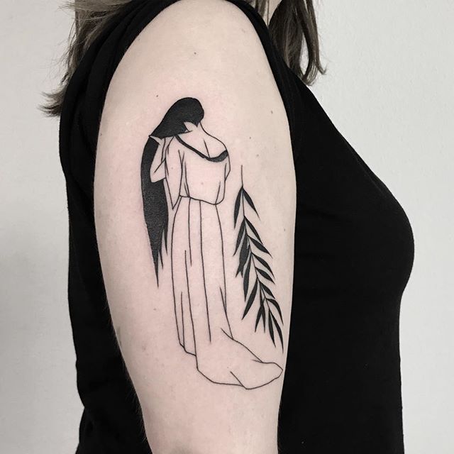 Woman and palm leaf tattoo on the arm