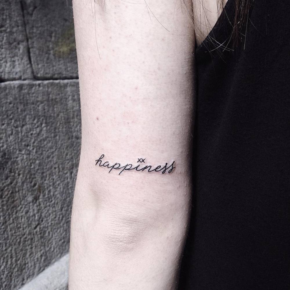Happiness tattoo on the arm