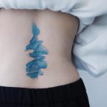 Abstract blue watercolor tattoo on the back