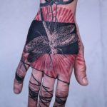 Abstract bug tattoo on the hand