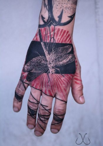 Abstract bug tattoo on the hand
