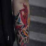 Abstract geometric shapes and red hand tattoo