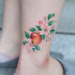 Apple tattoo on the ankle