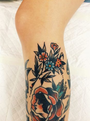 Beautiful flower tattoo on the calf
