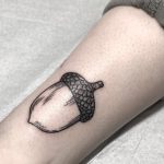 Black acorn tattoo