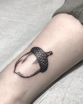 Black acorn tattoo