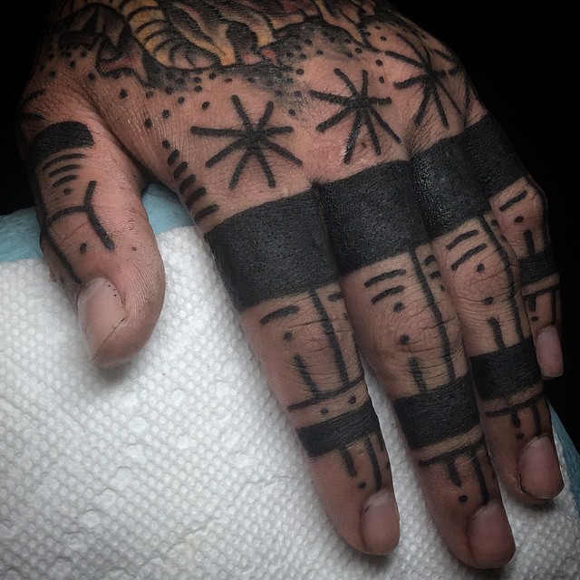 Black finger tattoos
