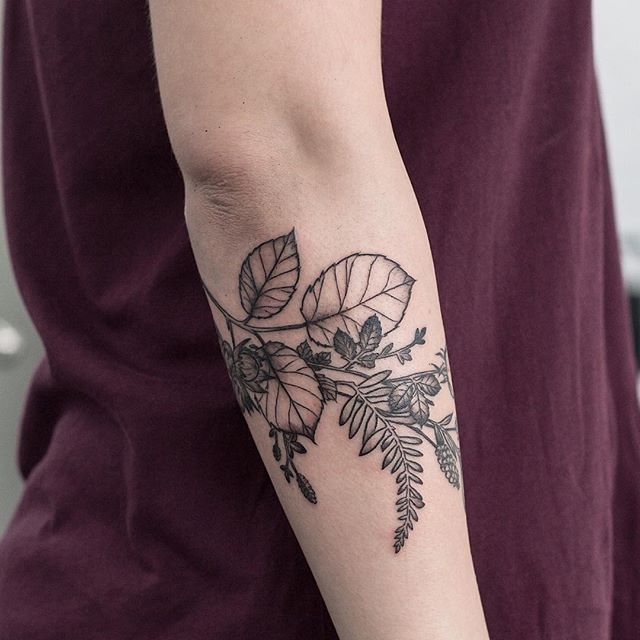 Black flower and plant tattoo
