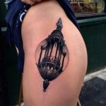 Black lantern tattoo on the hip