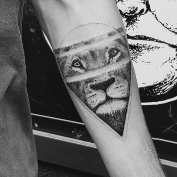 Black lion in a triangle tattoo