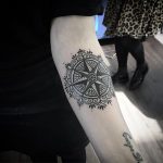 Black mandala and compass rose tattoo
