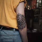 Black solid mandala tattoo on the elbow