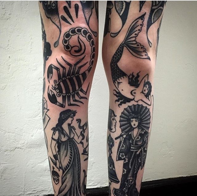 Black traditional tattoos on both legs
