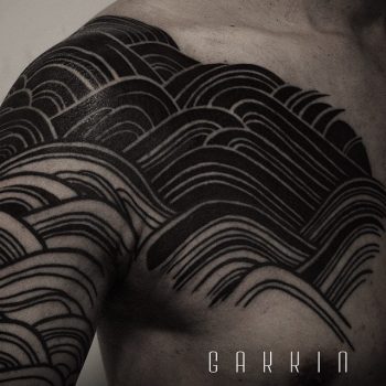 Black waves tattoo on the chest