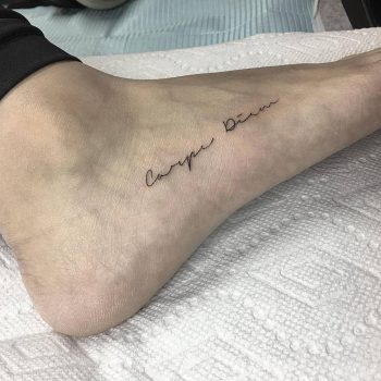 Carpe diem tattoo on the foot