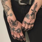 Chain, dagger, rose and butterfly tattoos
