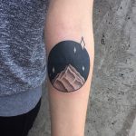 Circular mountain peak tattoo